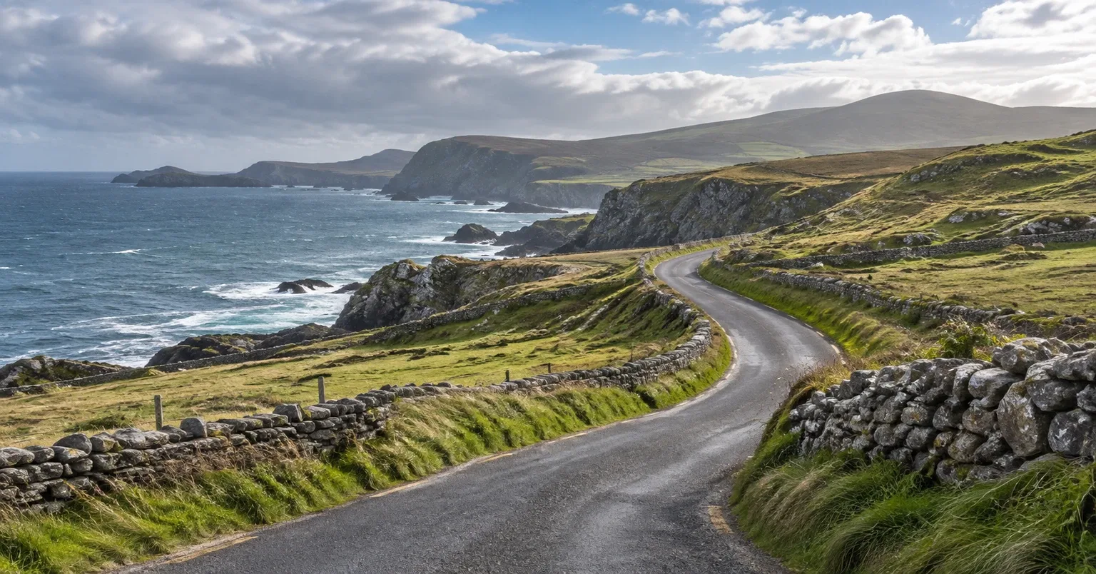 A winding coastal road crossing green headlands on Ireland's Atlantic coast